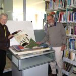 Getting ready to collaborate with UC students Dr Belle Alderman and Max Brown prepare artwork for viewing